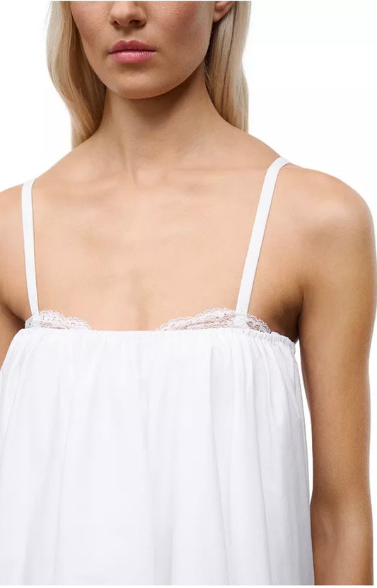 White lace-trimmed top worn by a model on a white background