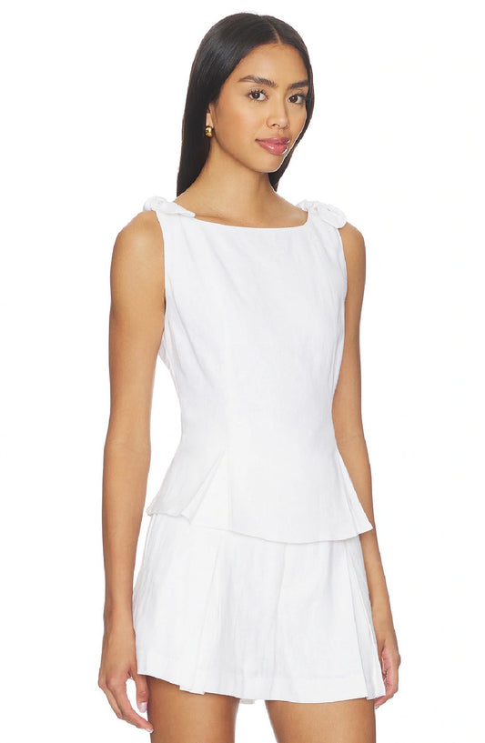 Woman wearing a white sleeveless dress on a white background