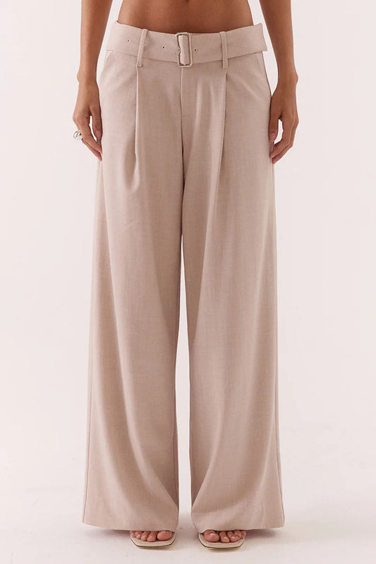 Beige wide-leg pants worn by a person on a white background
