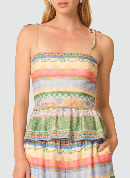 Woman wearing a colorful striped dress with a plain background