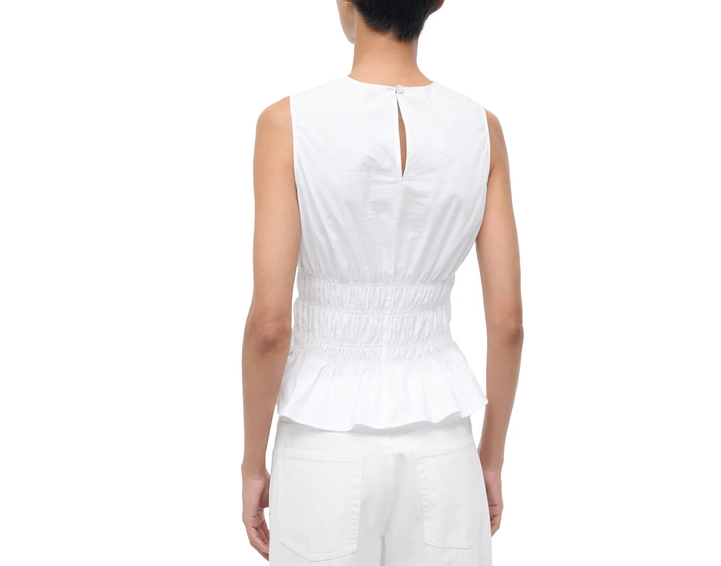 Person wearing a white sleeveless top and pants on a white background