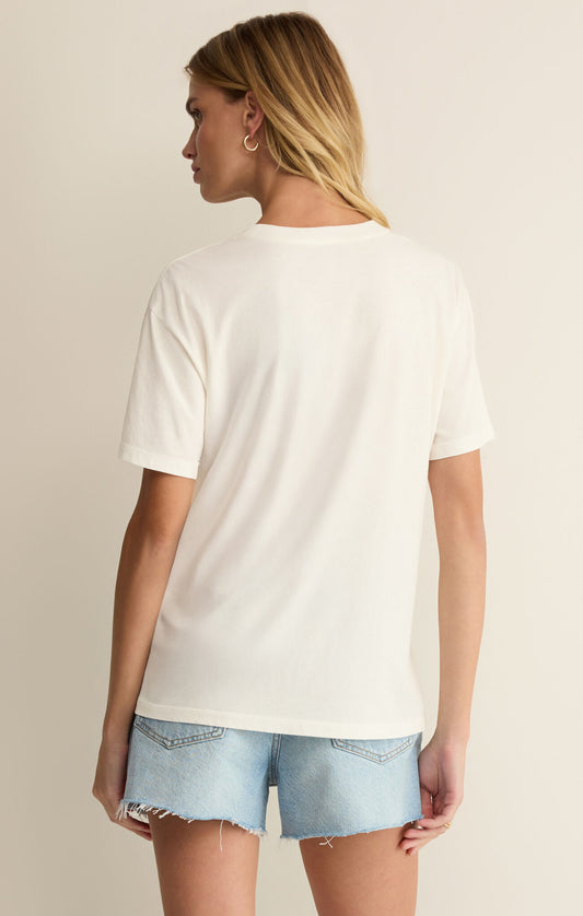 Woman wearing a plain white t-shirt and light blue denim shorts on a neutral background