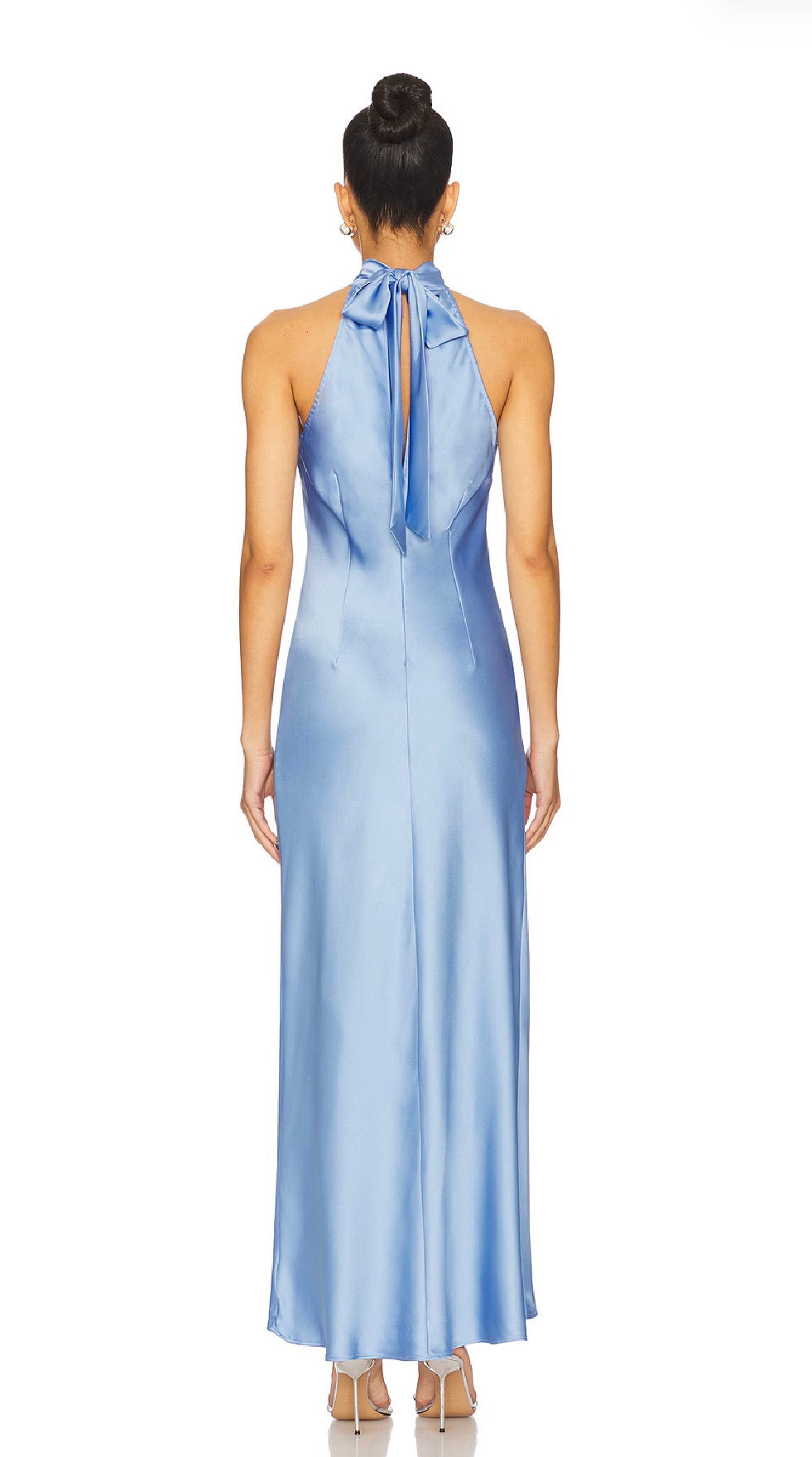 Woman wearing a light blue halter neck gown on a white background