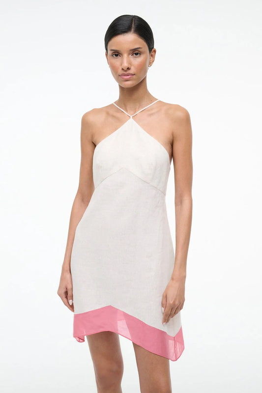 Woman wearing a white dress with pink hem on a white background