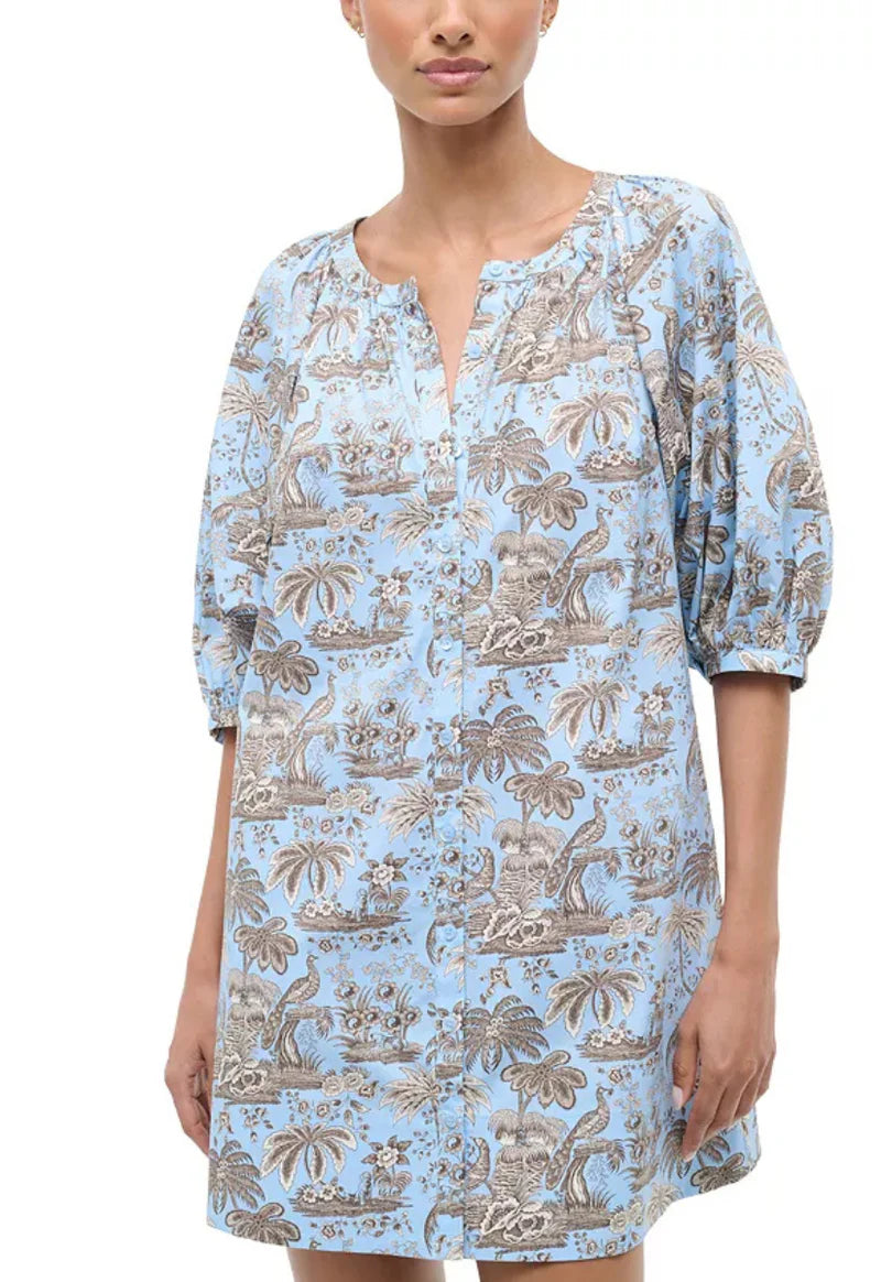 Woman wearing a blue patterned dress on a white background