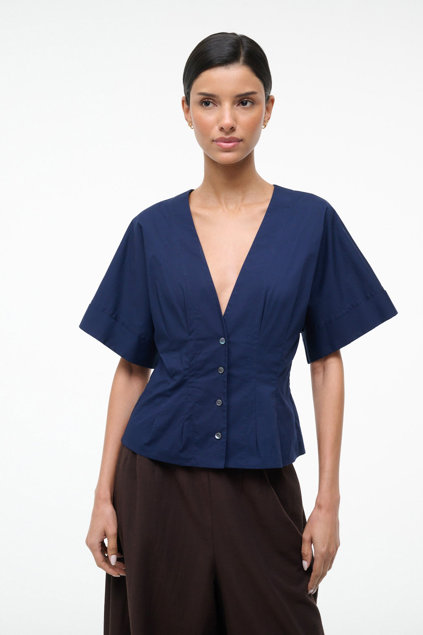 Woman wearing a blue blouse with a white background