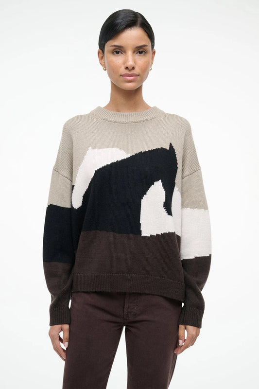 Woman wearing a sweater with a horse design on a white background