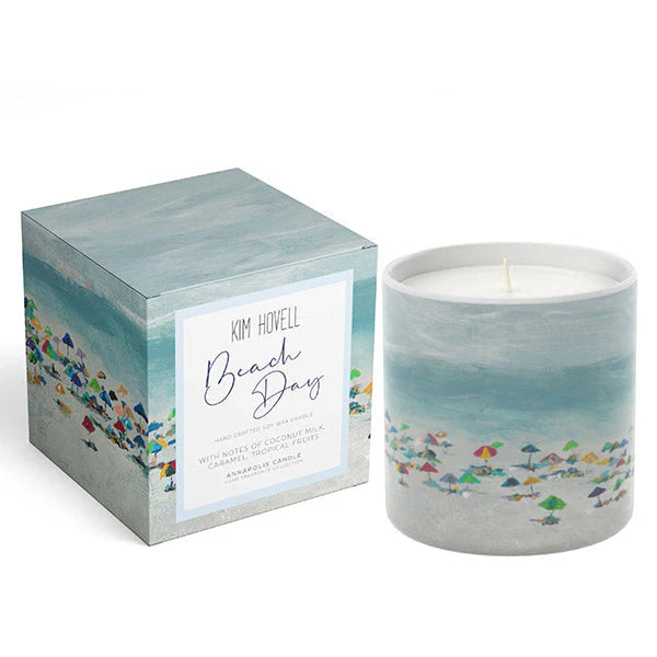 Candle with 'Beach Day' design and matching packaging on a white background. Notes of coconut milk, caramel, and tropical fruits