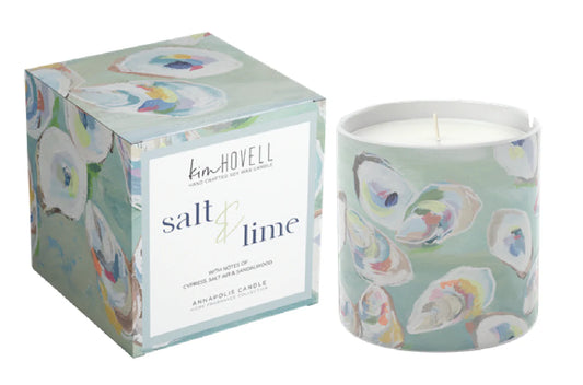 Candle with colorful oyster shell design and matching packaging on a white background. Scents of cypress salt air and sandalwood.