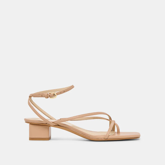 Dolce Vita light tan strappy leather sandal with a block heel on a light beige background