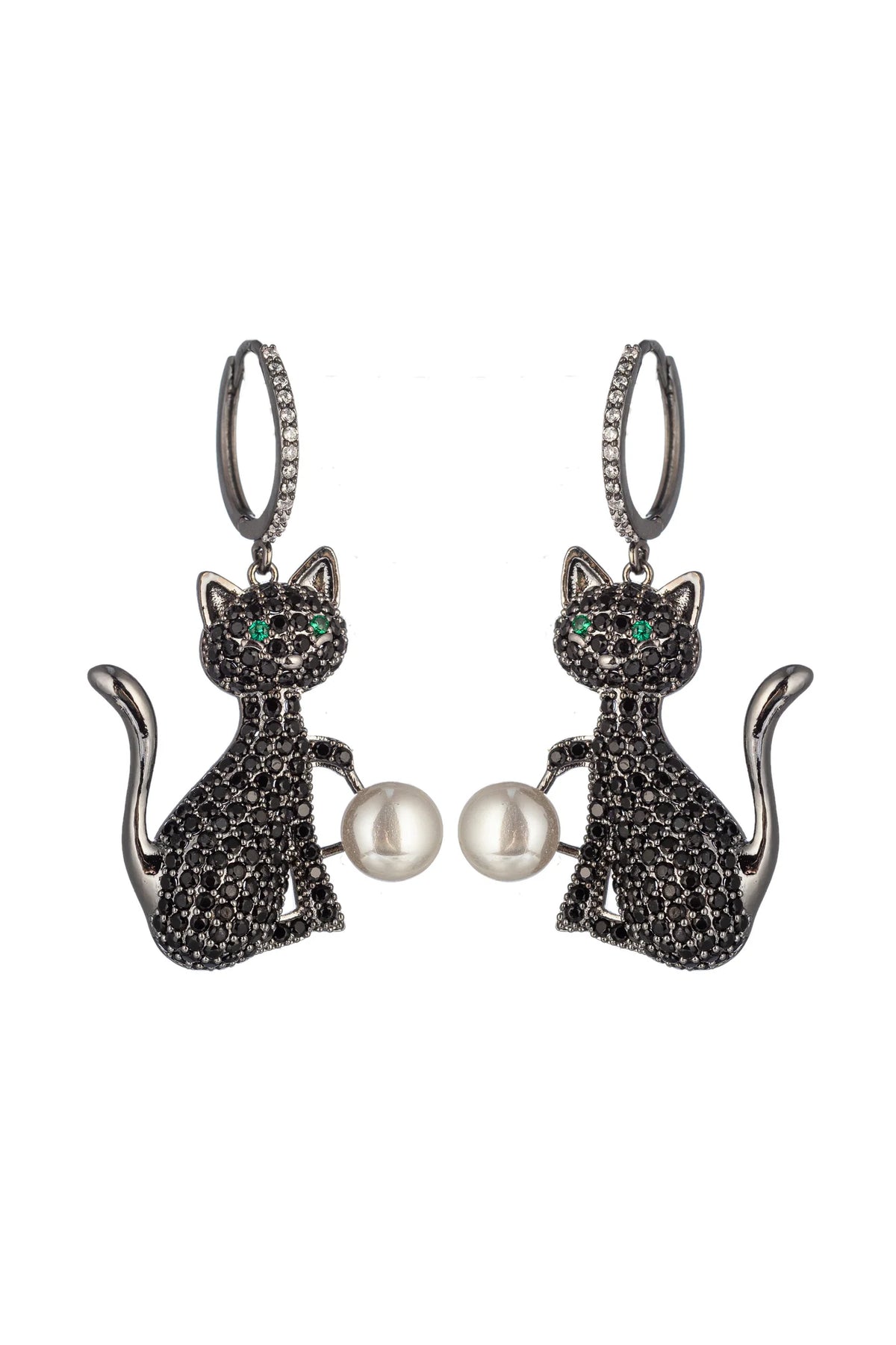 A pair of silver-tone dangle earrings shaped like sitting cats, covered in small black pavé stones, with green eye details and a white pearl held between the cats, on a plain white background.