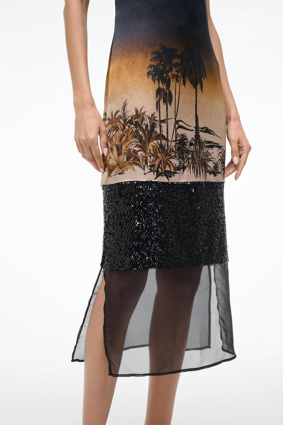 Dress with palm tree design and sequin skirt on a white background