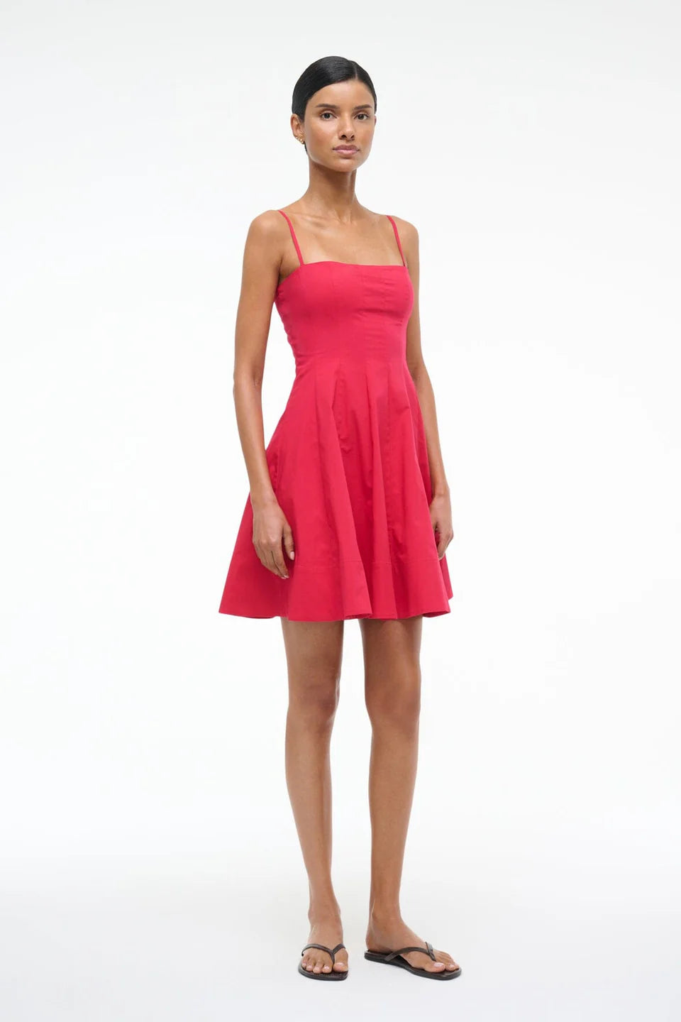 Woman wearing a pink dress on a white background