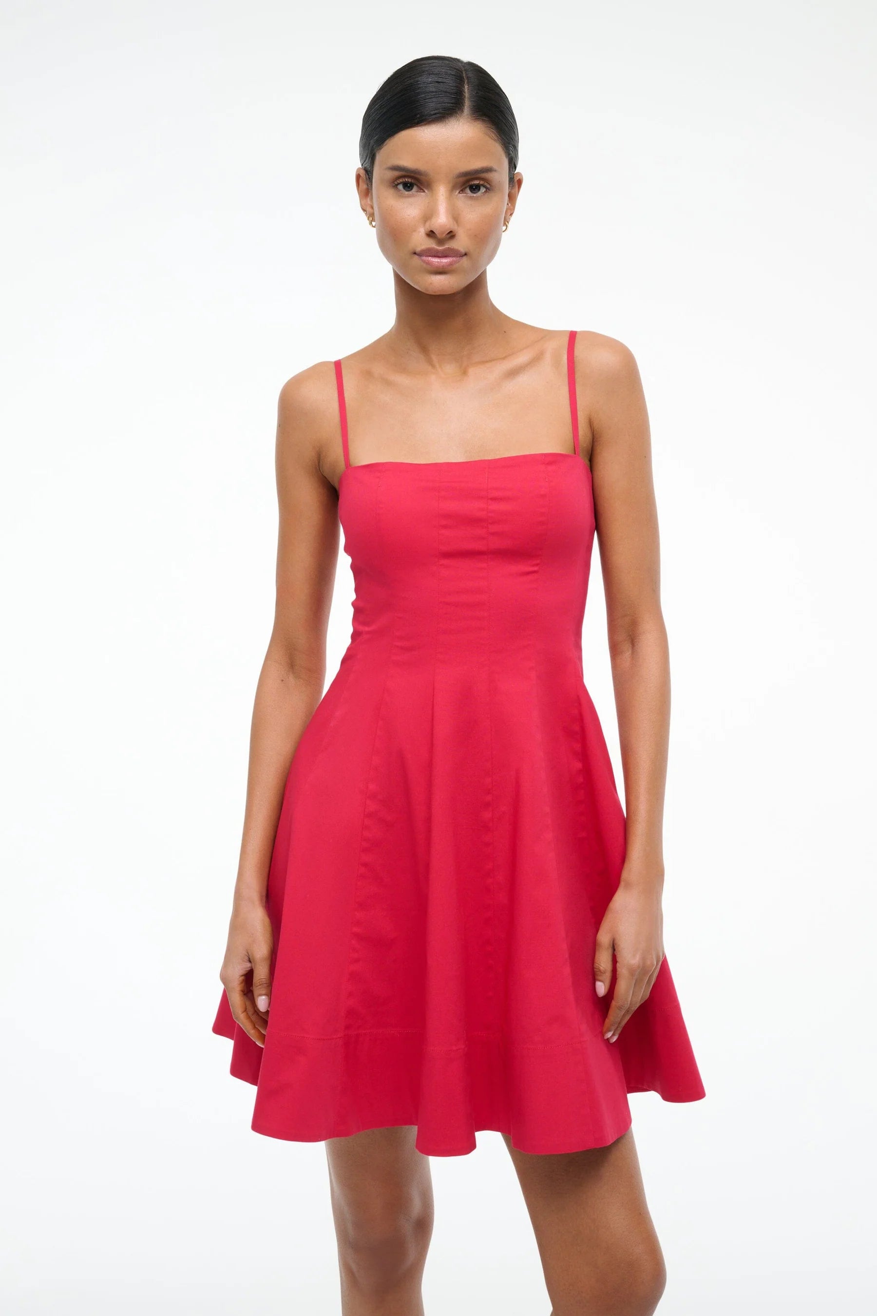 Woman wearing a red dress on a white background