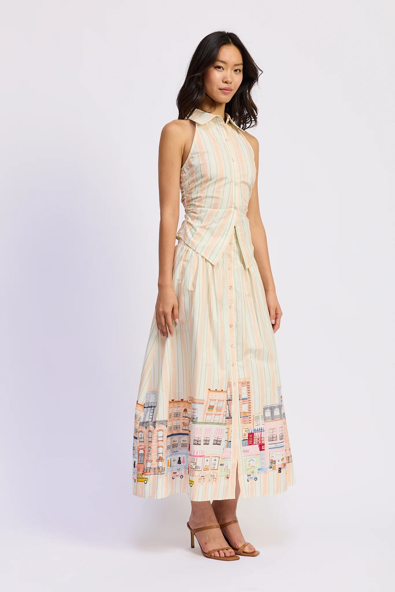 Woman wearing a patterned dress on a white background