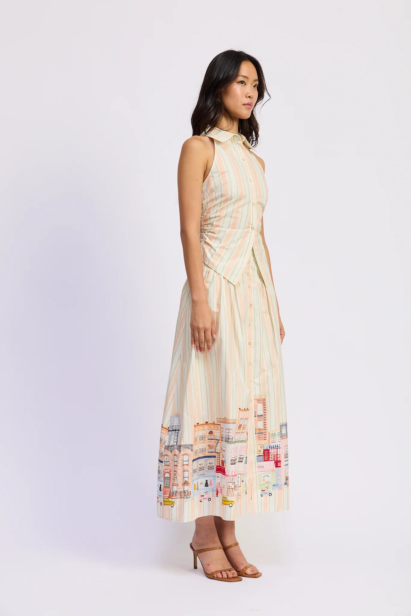 Woman wearing a sleeveless dress with a pattern on a white background