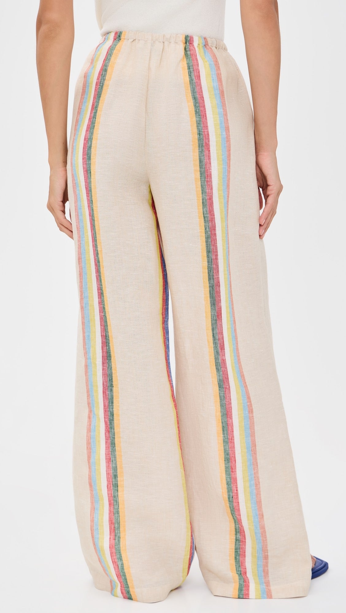 Beige wide-leg pants with colorful stripes on a white background