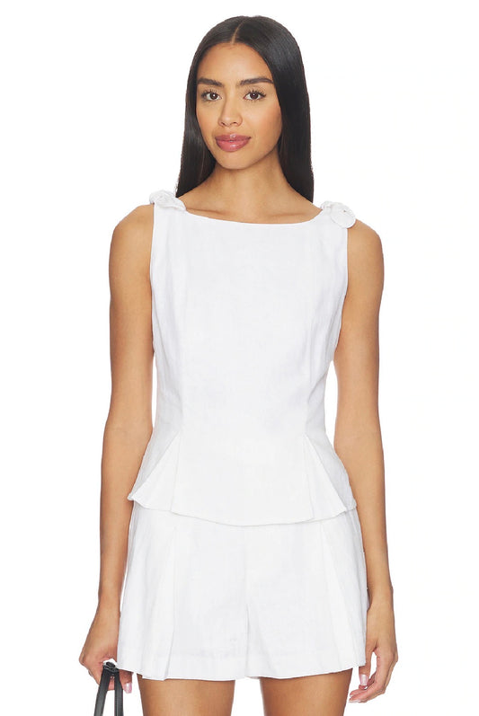 Woman wearing a white sleeveless top and skirt set on a white background