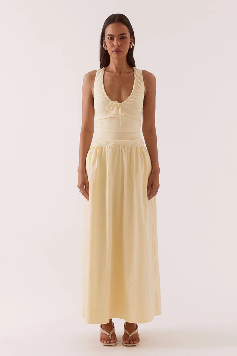 Woman wearing a beige sleeveless dress on a white background