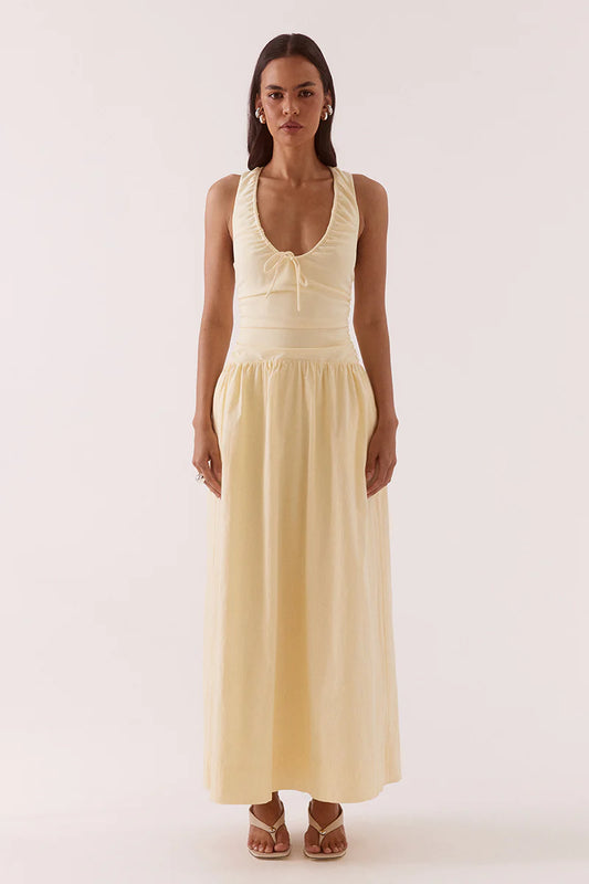 Woman wearing a beige sleeveless dress on a white background
