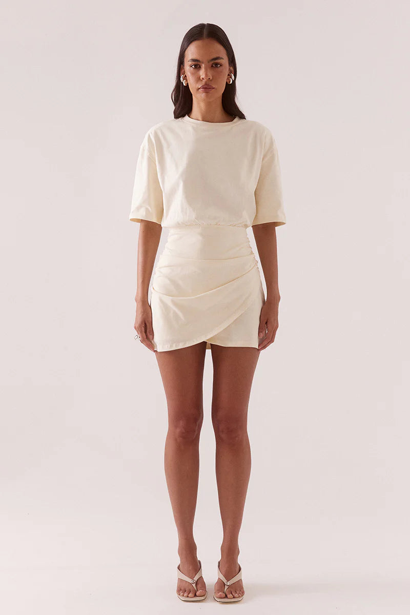 Woman wearing a white dress on a plain background