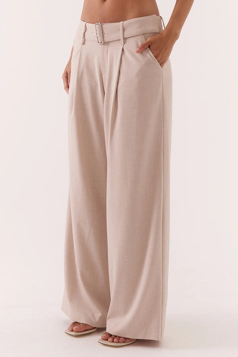 Beige wide-leg pants worn by a person on a white background