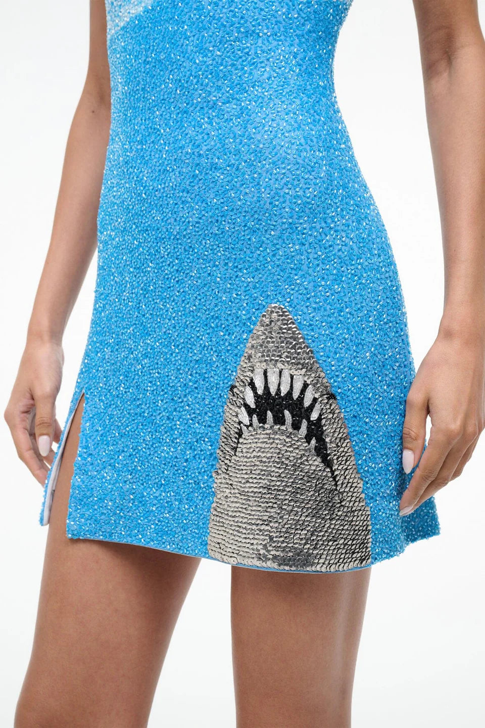 Blue sequin dress with a shark mouth design on a white background