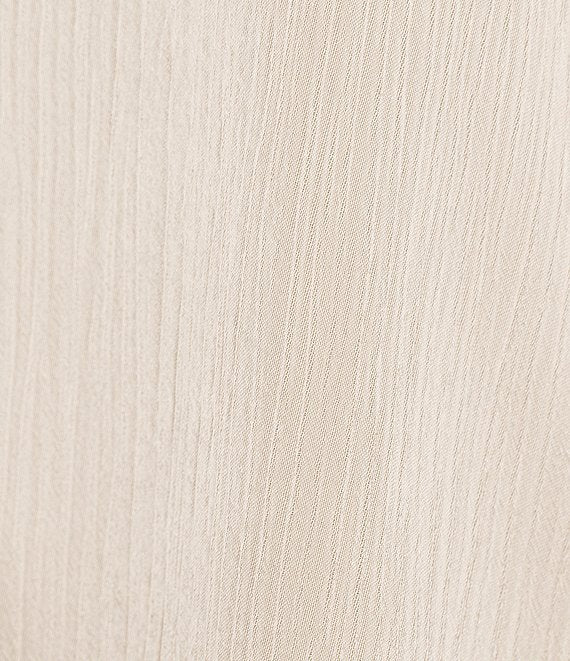 A close-up texture shot of a light beige fabric with a fine vertical ribbed pattern.