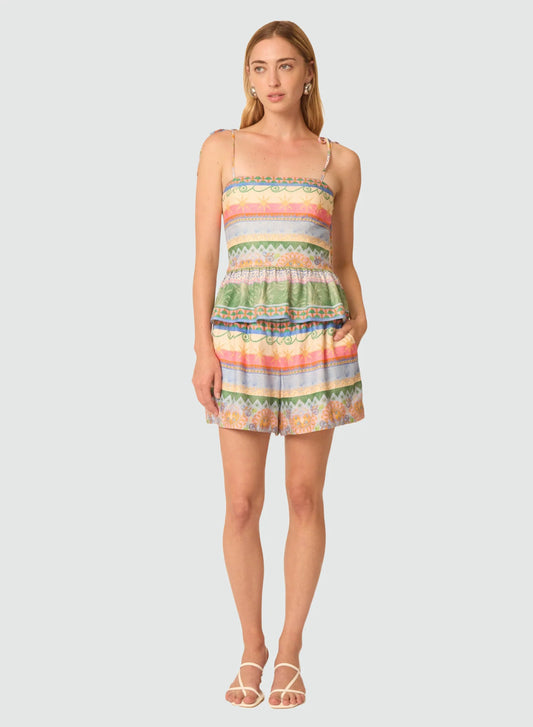 Woman wearing a colorful striped dress on a white background