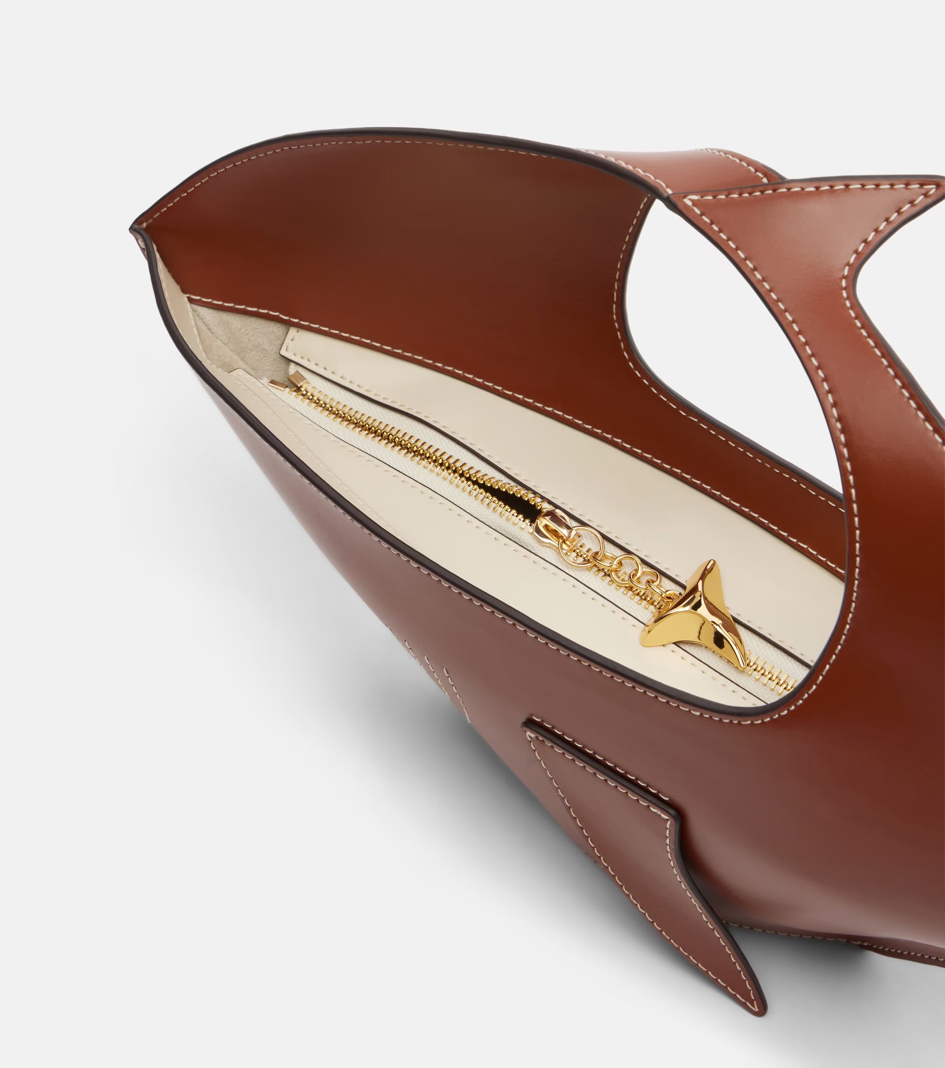 Brown high-heeled shoe with cut-out design on a white background