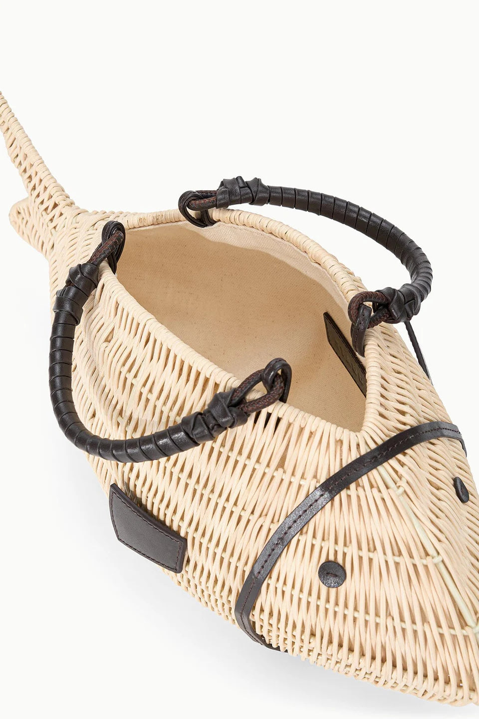 Woven handbag with black straps on a white background