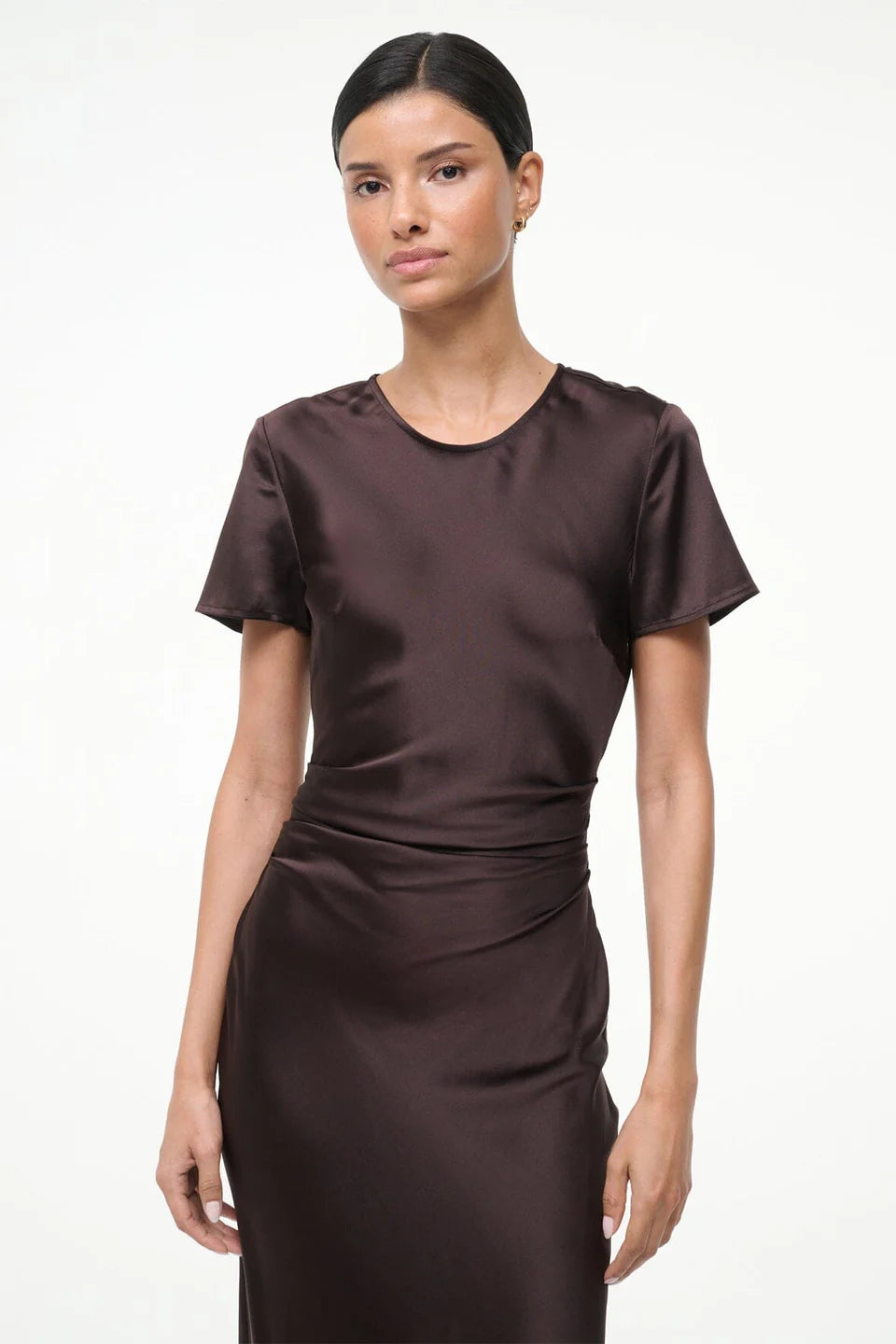 Woman wearing a brown dress on a white background