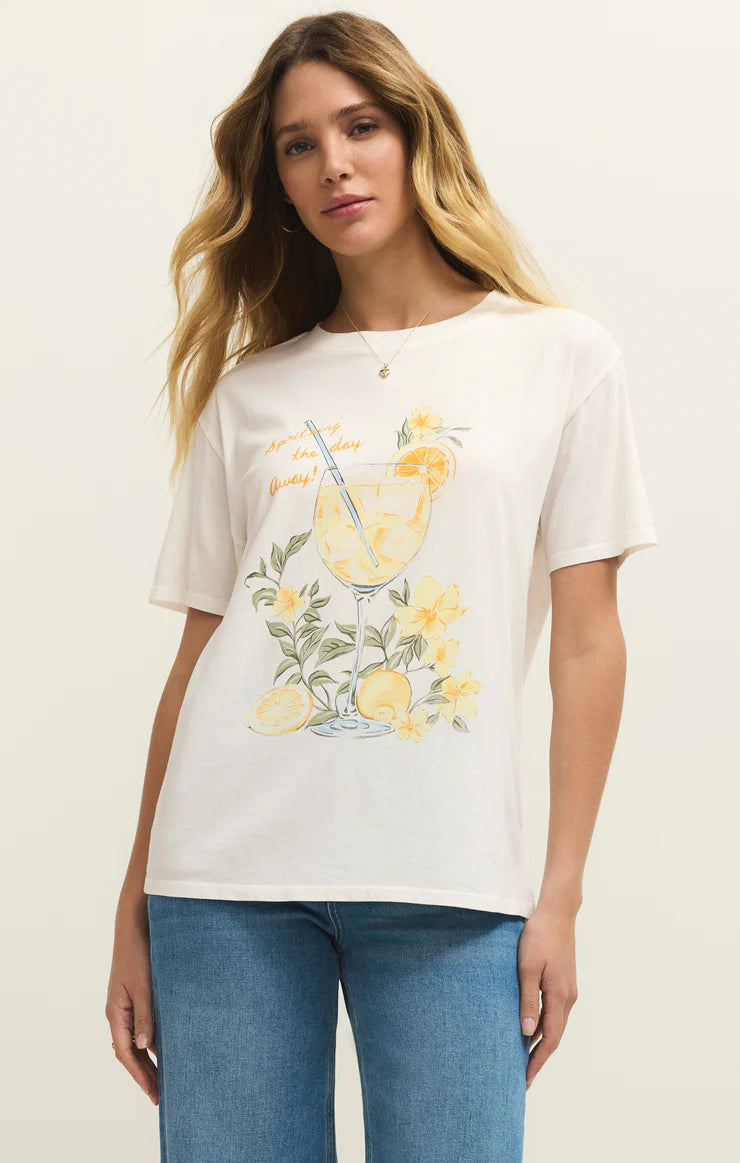 Woman wearing a white t-shirt with a lemon-themed design on a plain background
