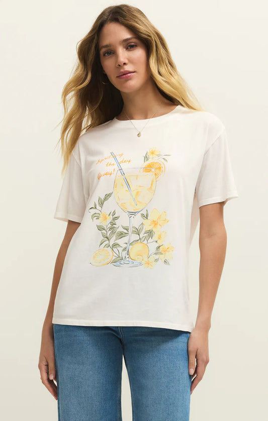 Woman wearing a white t-shirt with a lemon-themed design on a plain background