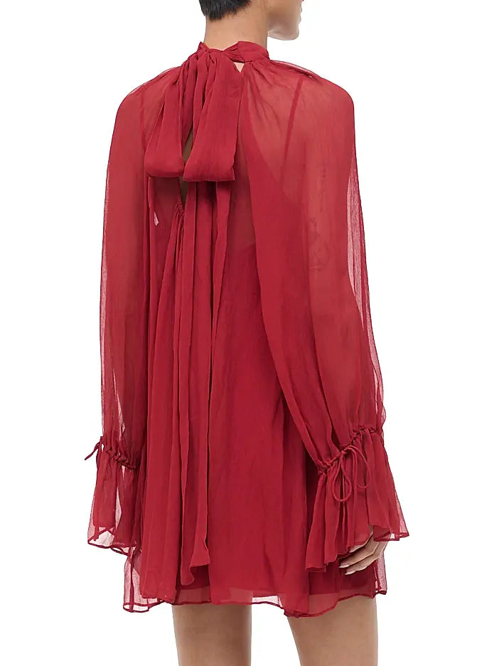 Red sheer dress with long sleeves on a white background
