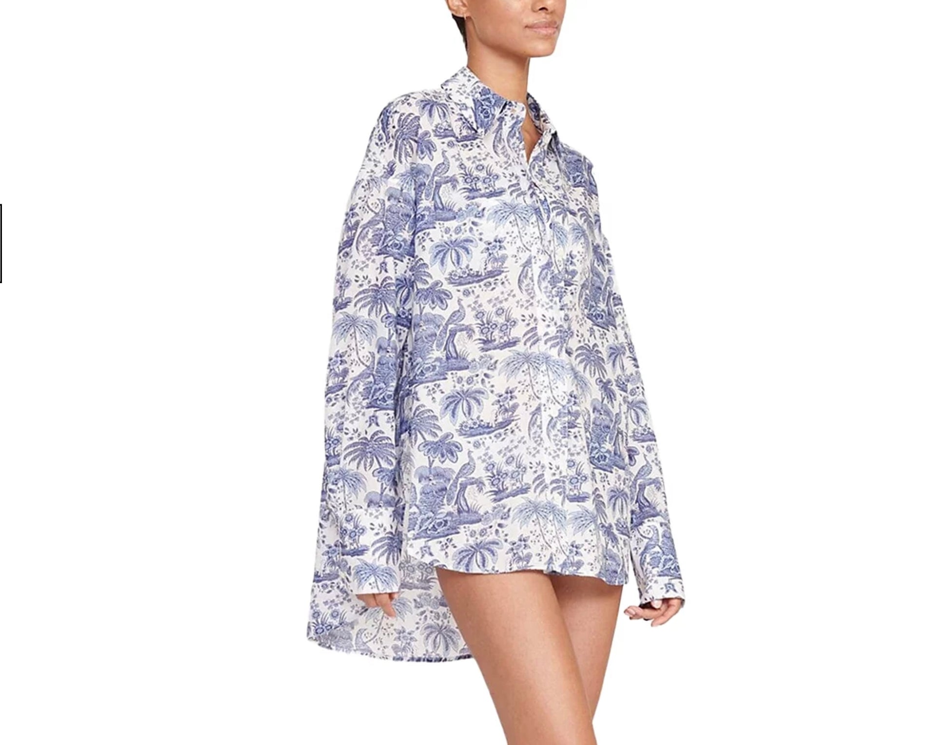 Woman wearing a blue and white floral patterned shirt on a white background