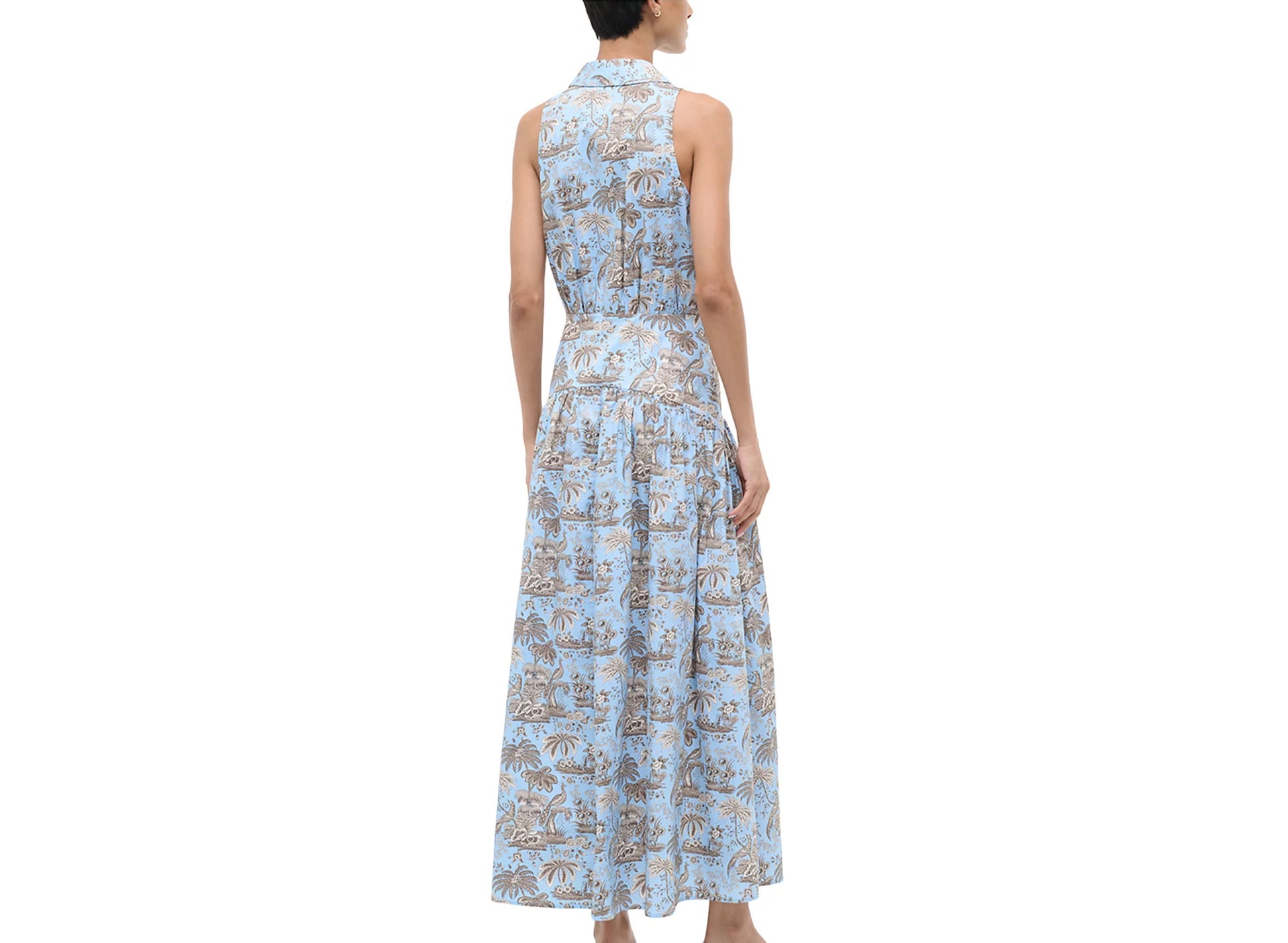 Woman wearing a blue floral dress on a white background