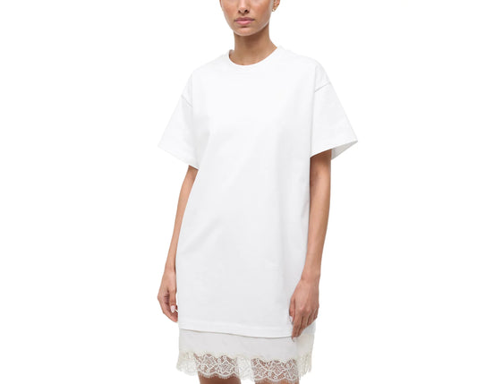 White t-shirt dress with lace trim worn by a model on a white background