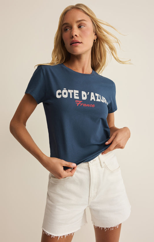 Woman wearing a navy blue t-shirt with 'Côte d'Azur France' text on a plain background