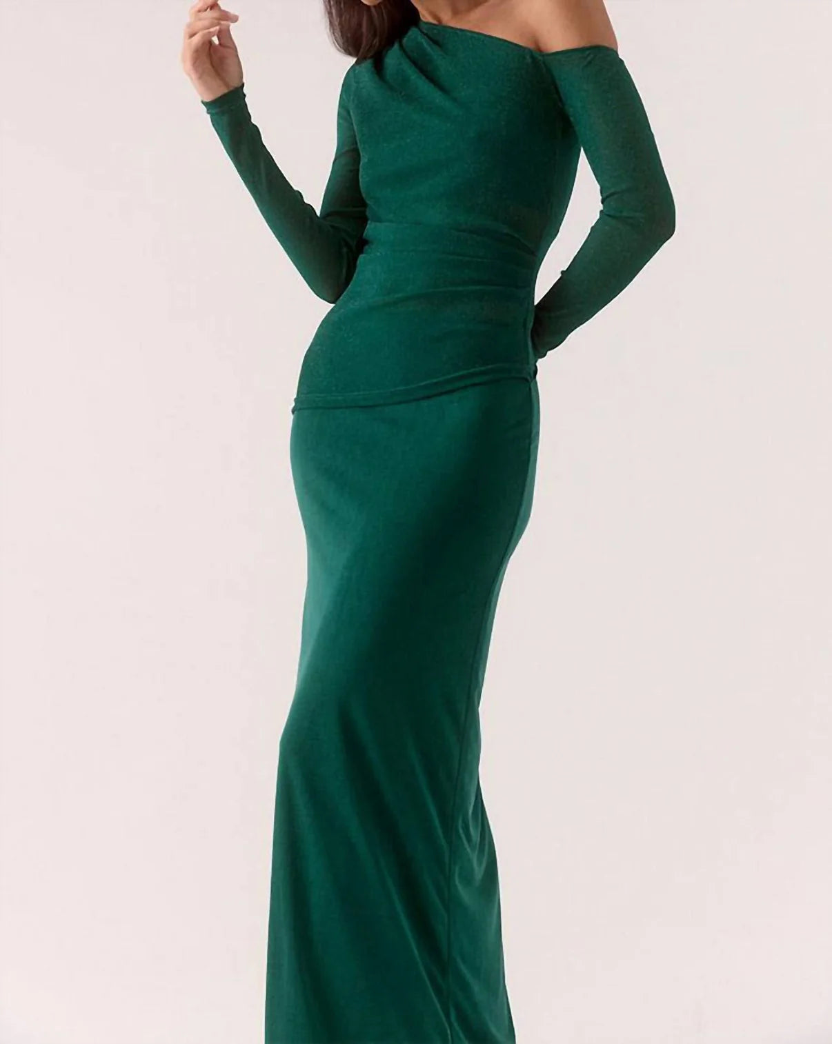 Green evening gown with long sleeves on a white background