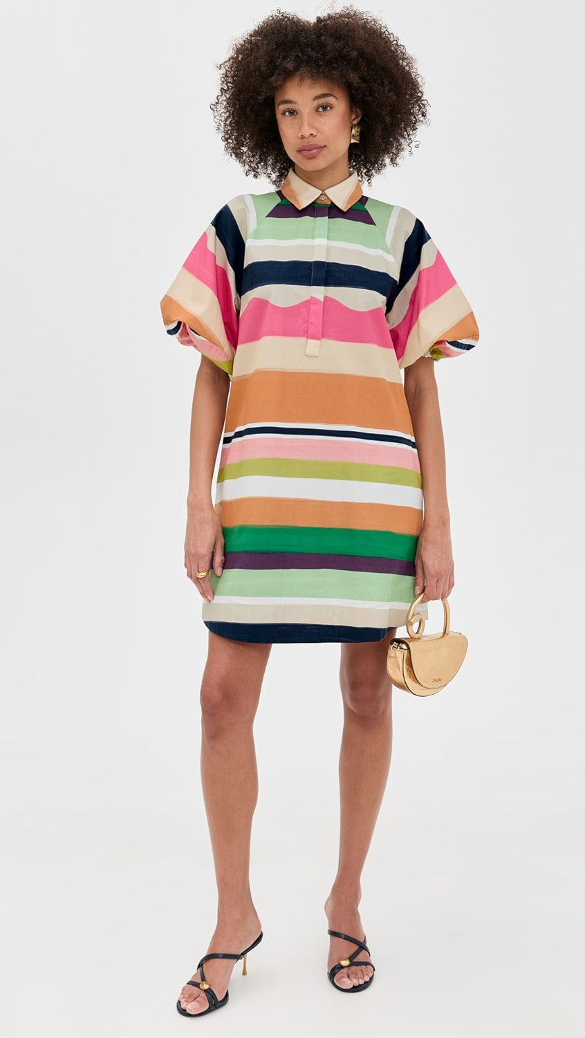 Woman wearing a colorful striped dress on a white background