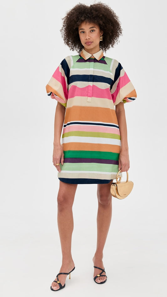 Woman wearing a colorful striped dress on a white background