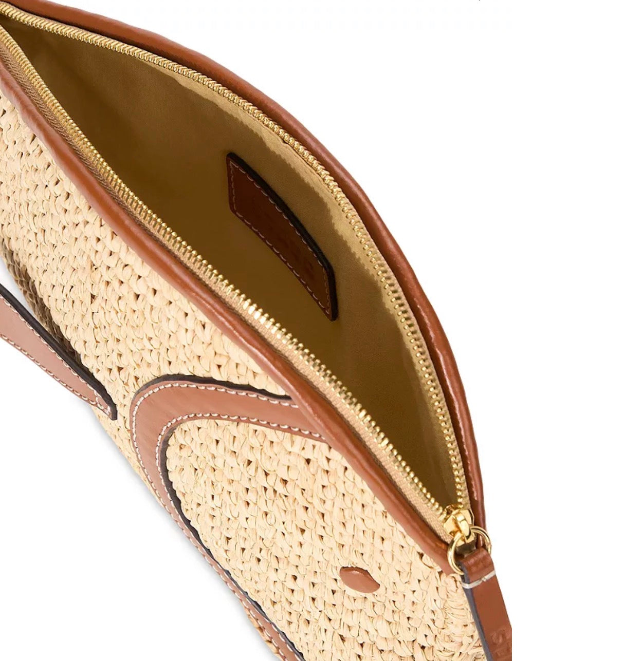 Close-up of a straw handbag with brown leather accents on a white background
