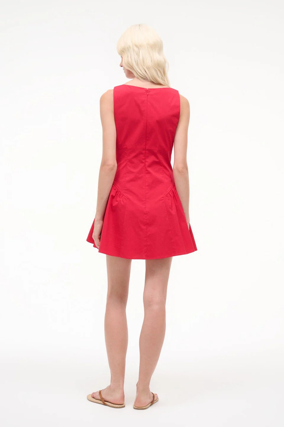 Woman wearing a red dress on a white background