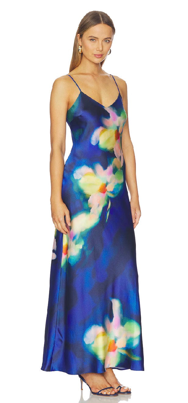 Woman wearing a colorful floral dress on a white background