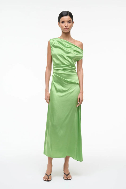 Woman wearing a green one-shoulder dress on a white background