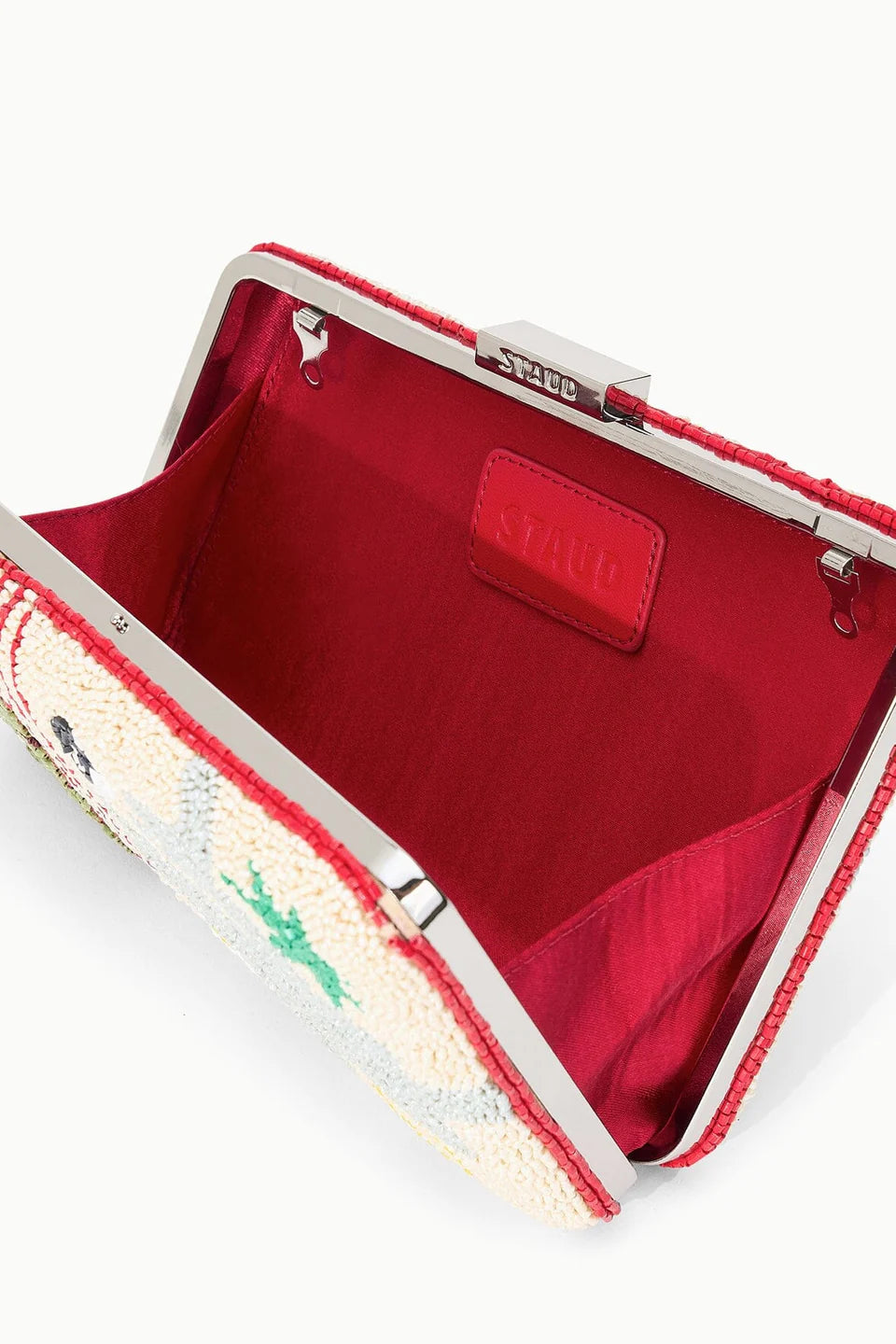 Open red clutch bag with floral pattern on a white background