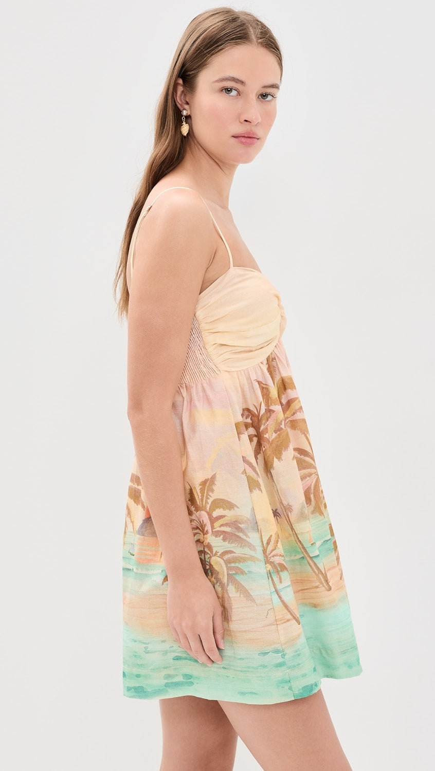 Woman wearing a tropical print dress on a white background