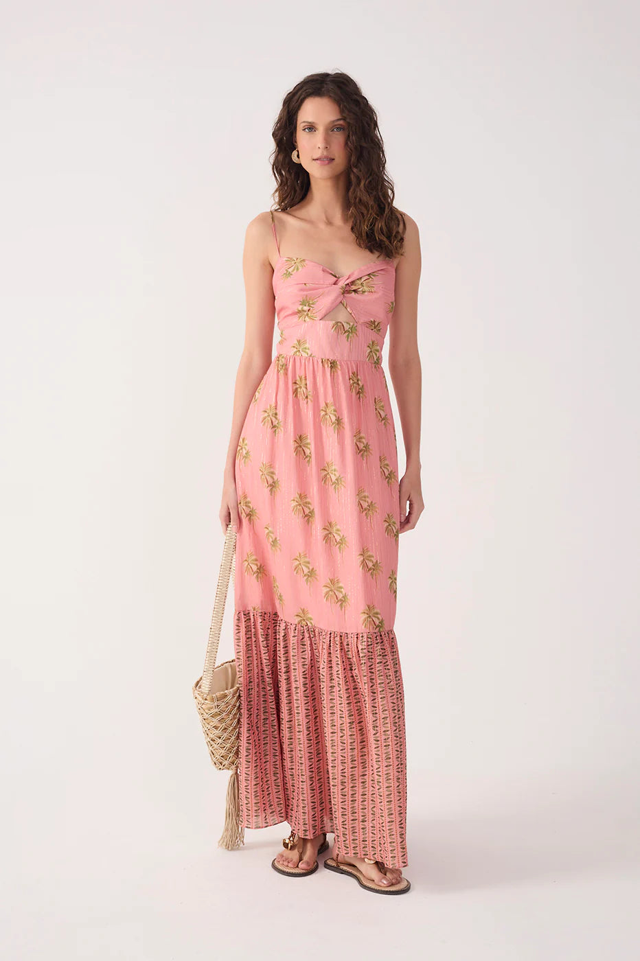 Woman wearing a pink floral dress with a white background