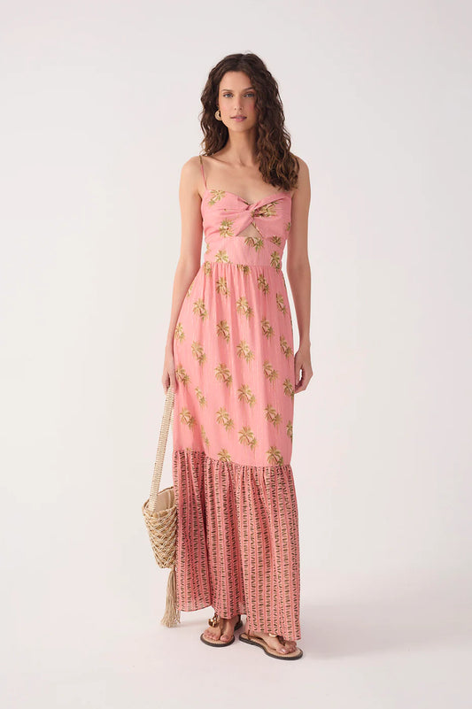 Woman wearing a pink floral dress with a white background